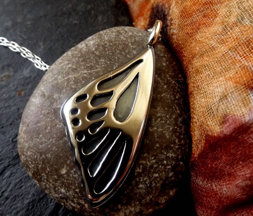 Silver Butterfly wing necklace pendant with oxidized background