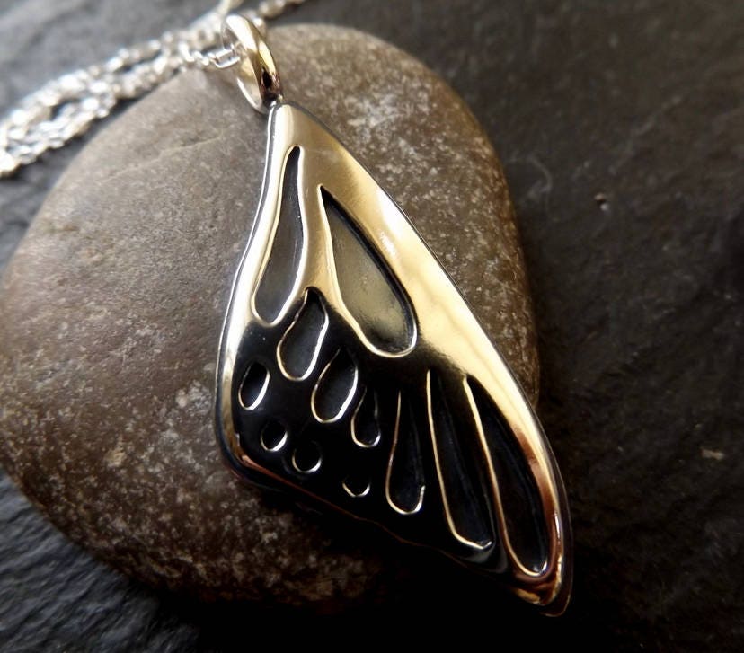 Silver Butterfly wing necklace pendant with oxidized background