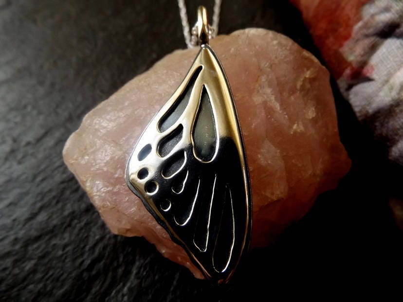Silver Butterfly wing necklace pendant with oxidized background