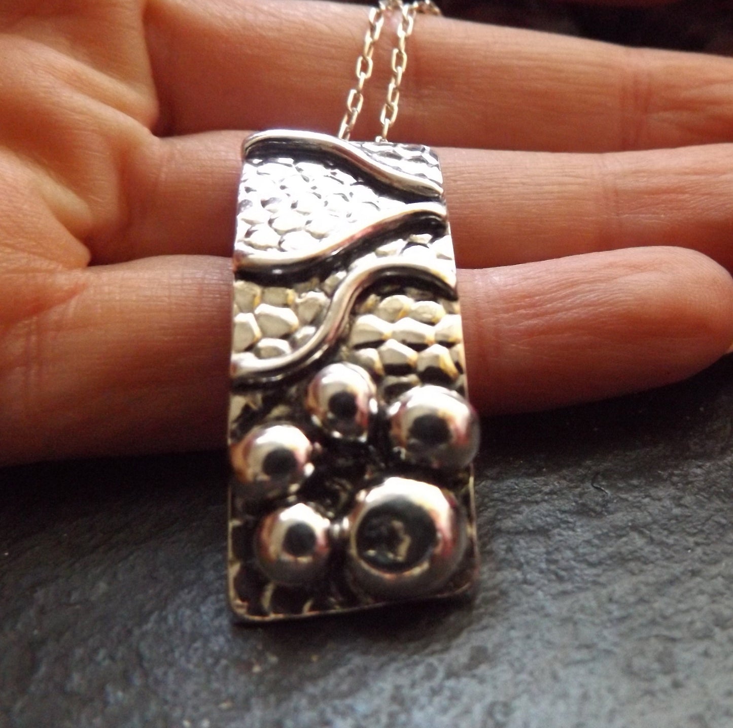 Silver pebble and wave textured sea lover pendant necklace