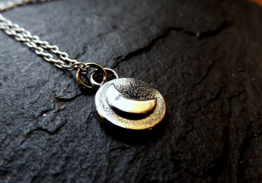 Silver moon necklace with textured background and polished finish , small moon pendant