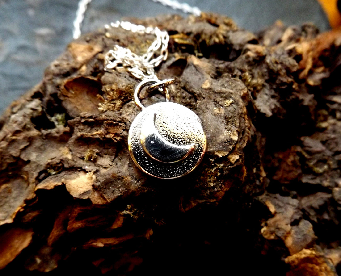 Silver moon necklace with textured background and polished finish , small moon pendant