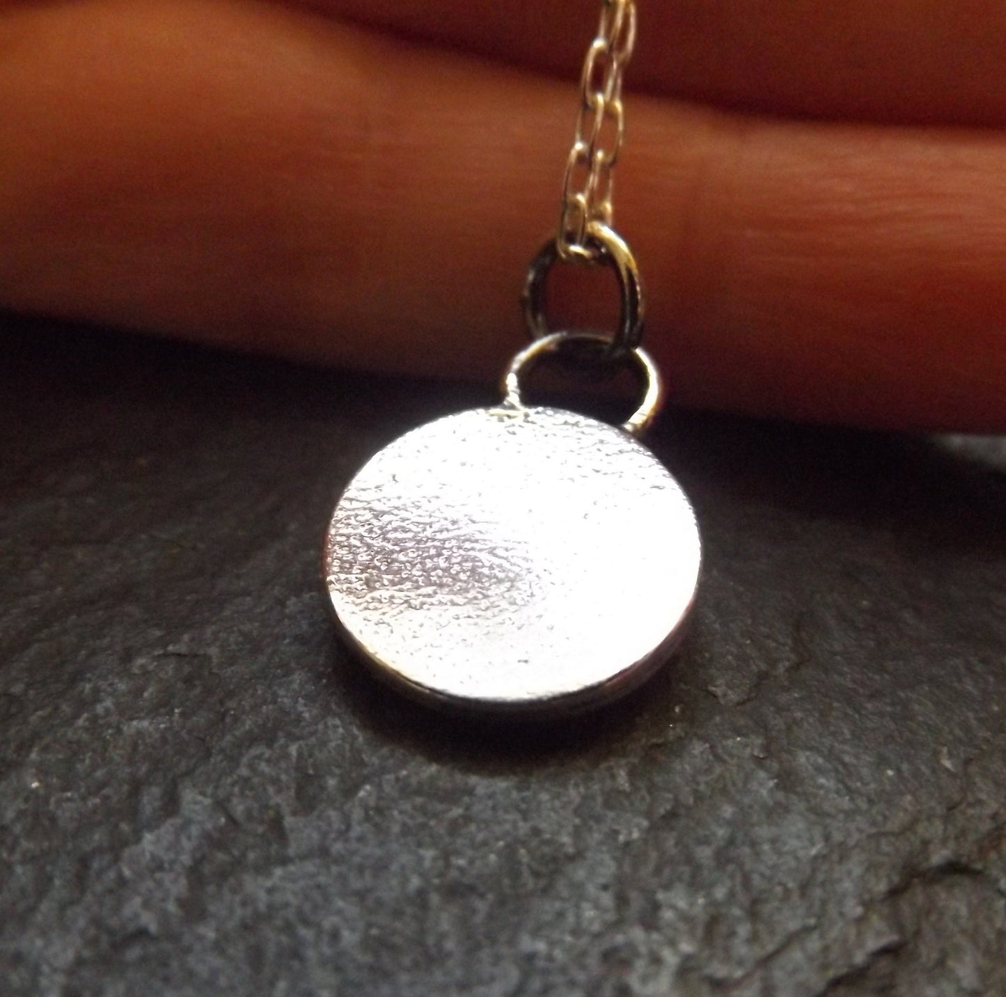 Silver moon necklace with textured background and polished finish , small moon pendant