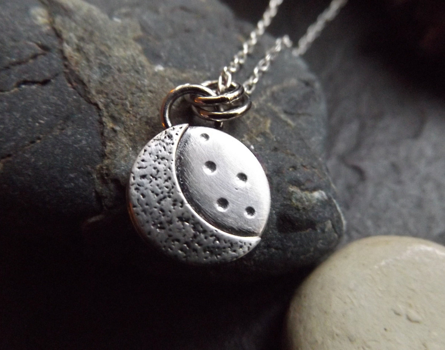 Silver crescent moon necklace with textured background and brushed polished finish , small moon pendant