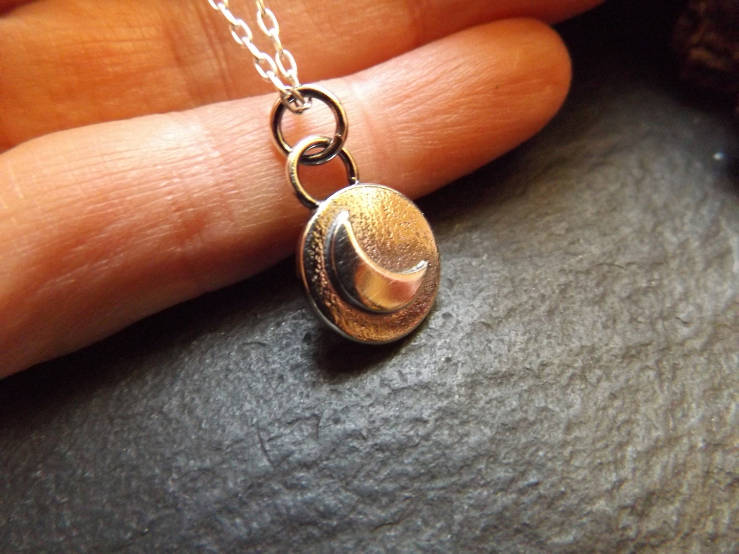 Silver moon necklace with textured background and polished finish , small moon pendant