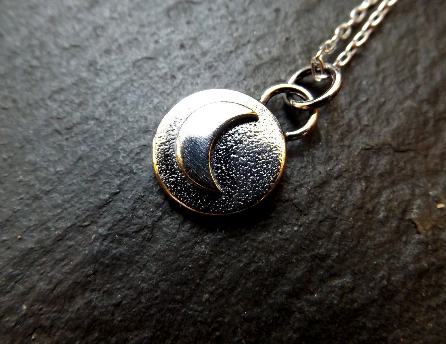 Silver moon necklace with textured background and polished finish , small moon pendant