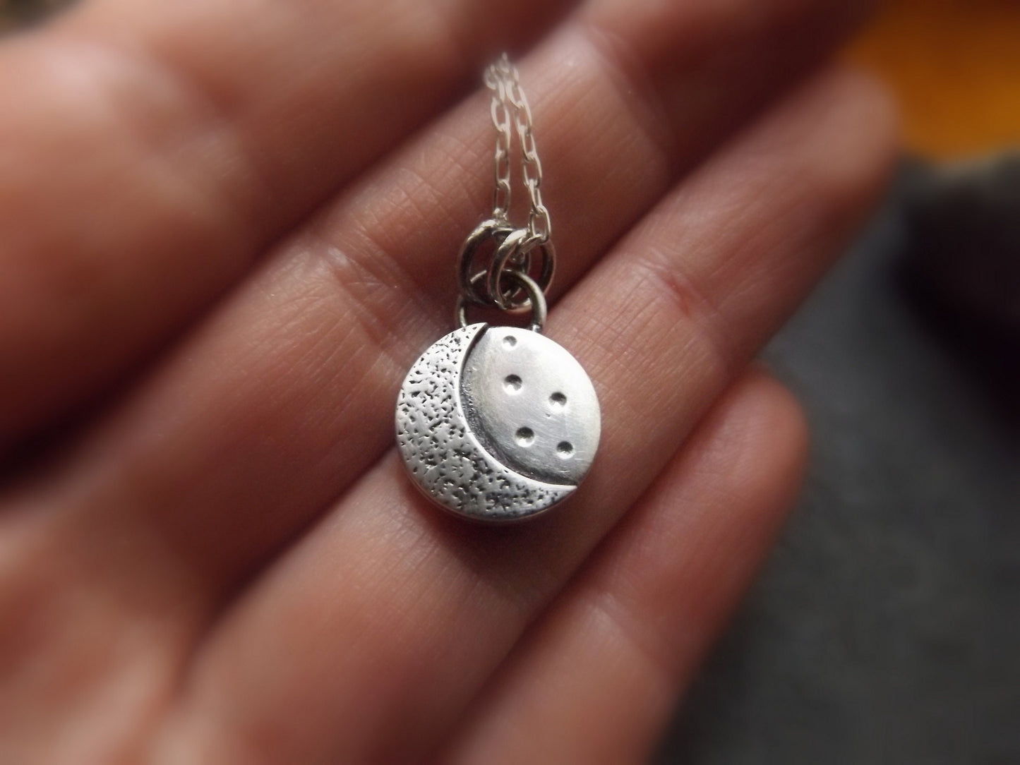 Silver crescent moon necklace with textured background and brushed polished finish , small moon pendant