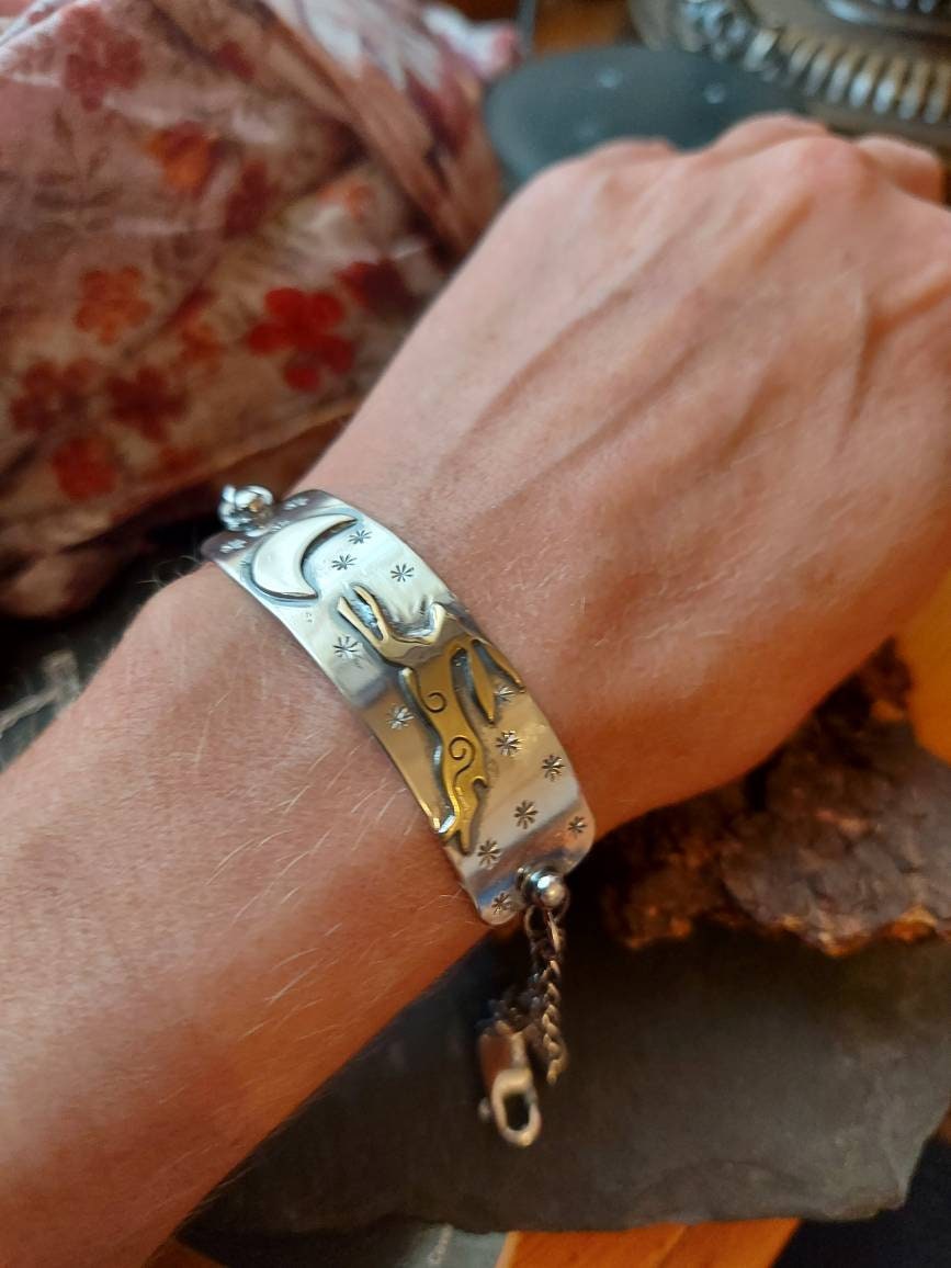 Silver leaping hare with Moon and Stars bar bracelet with star and moon charms, and brass hare