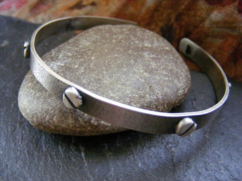 Silver oxidised textured industrial cuff with silver rivets and satin finish