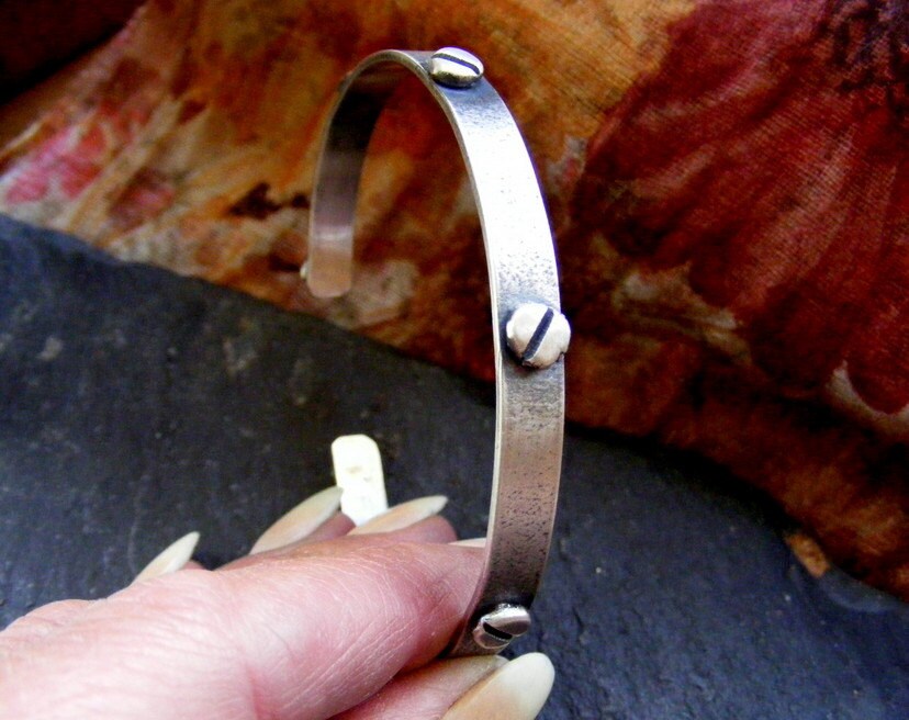 Silver oxidised textured industrial cuff with silver rivets and satin finish