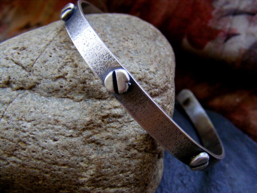Silver oxidised textured industrial cuff with silver rivets and satin finish