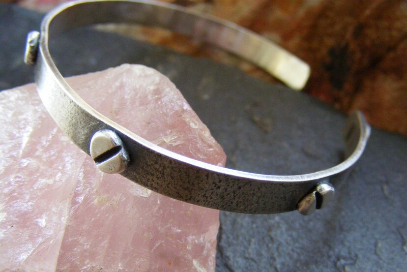Silver oxidised textured industrial cuff with silver rivets and satin finish