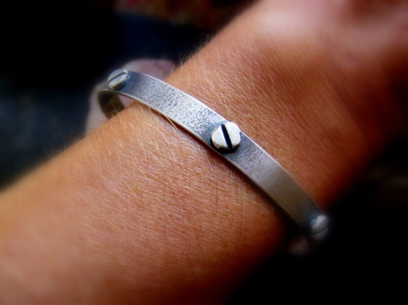 Silver oxidised textured industrial cuff with silver rivets and satin finish