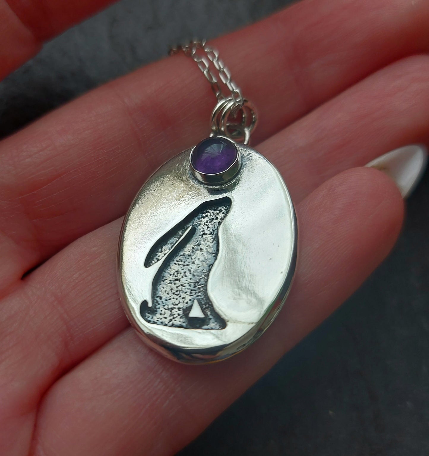 Silver oval hare pendant with textured background and 6mm amethyst , cut out hare pendant